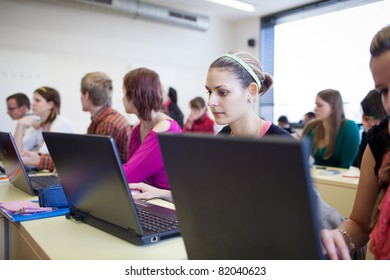 College Students Sitting In A Classroom, Using Laptop Computers During Class (shallow DOF)