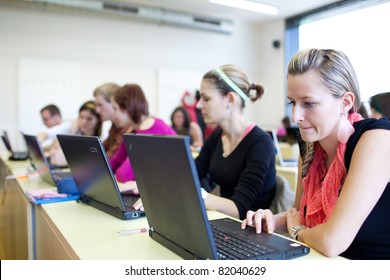 College Students Sitting In A Classroom, Using Laptop Computers During Class (shallow DOF)