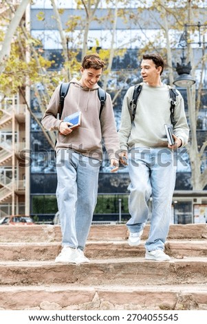 College students talking while walking down outdoor stairs