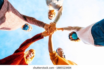 College Students Teamwork Stacking Hands - New Normal Lifestyle Concept With People Covered By Face Mask Helping Each Other