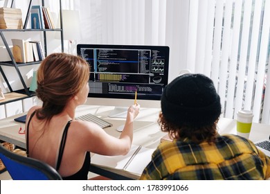 College students watching webinar on computer science at home and discussing programming code on computer screen - Powered by Shutterstock