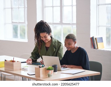 College Students Working Together Two Young Women Friends Brainstorming Ideas For Project Sitting At Desk Using Laptop Computer In Class