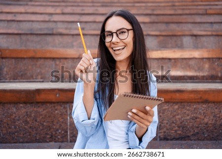 College study programs, academic educational courses, learning classes concept. Evrica, have idea. Smiling woman sitting on city stairs outdoors writing notes, female student study outside