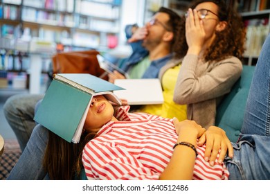 College, Study, University And Education Concept. Group Of Tired Students Learning In Library