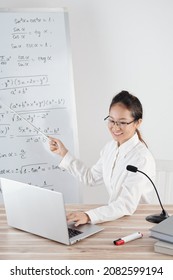 College Teacher Conducting Online Lesson, Speaking In Microphone And Pointing At White Board