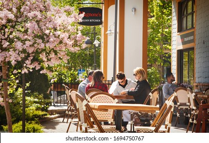 COLLINGWOOD, ON, CANADA - JUNE 16, 2019: Group of people are looking at menu and making order in restaurant, Blue Mountain Resort, ON, Canada