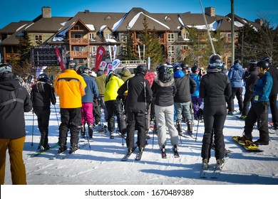Collingwood, Ontario, Canada - February 23, 2020: Back view of people lining up for the lift in ski hill of Blue Mountain Village.