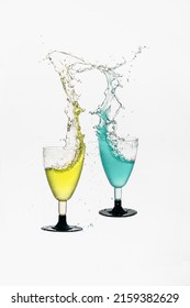A collision of two glasses with colorful liquids with water splash from glass on a white background
