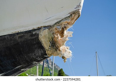 The collision-damaged bow of the fiberglass yacht. - Shutterstock ID 2237594281