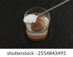 Colloidal silicon dioxide in spoon for dissolved in water. Enterosorbent. Preparation of suspension to relieve a hangover after holidays or poisoning. Concept of Intoxication.