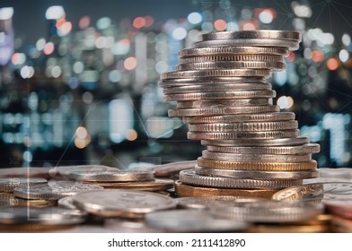 Collumns of coins on background of night cityscape and financical diagram. Financical and banking concept