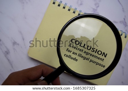 Collusion Meaning Concept write on a book isolated on Office Desk.