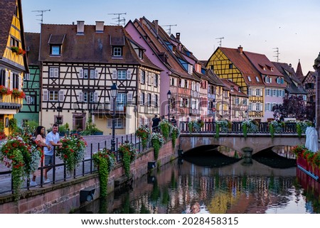 Colmar, Alsace, France. Petite Venice, water canal, and traditional half timbered houses. Colmar is a charming town in Alsace, France. couple man and women walking at the street during vacation