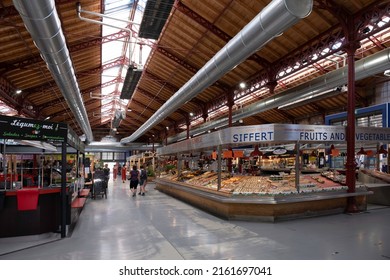 COLMAR, FRANCE - MAY 20 2022: People Shop At Fruit And Vegetable Department In The Covered Market Hall In Colmar. Local And Organic Products