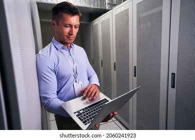 Colocation data center engineer working on notebook computer