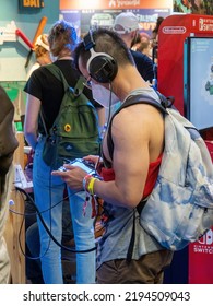 COLOGNE - AUG 25, 2022: Interested Visitor At The Stand At Gamescom In Cologne