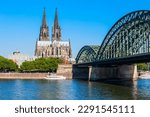 Cologne Cathedral and Hohenzollern Bridge through Rhine river in Cologne, Germany