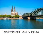 Cologne Cathedral and Hohenzollern Bridge through Rhine river in Cologne, Germany