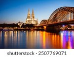 Cologne Cathedral and Hohenzollern Bridge through Rhine river in Cologne, Germany