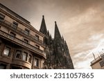 Cologne Cathedral with a residential apartment building in front with blue sky. Cologne Cathedral, or Kolner Dom, is the main landmark of Cologne and a catholic church in Germany.