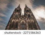 Cologne Cathedral seen from below with blue sky. Cologne Cathedral, or Kolner Dom, is the main landmark of Cologne and a catholic church in Germany.
