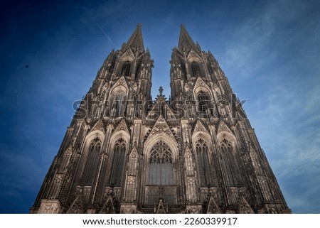 Cologne Cathedral seen from below with blue sky. Cologne Cathedral, or Kolner Dom, is the main landmark of Cologne and a catholic church in Germany.