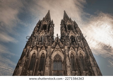Cologne Cathedral seen from below with blue sky. Cologne Cathedral, or Kolner Dom, is the main landmark of Cologne and a catholic church in Germany.
