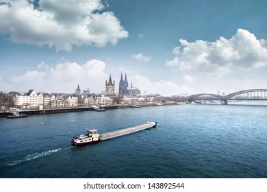 Cologne City Line With Cargo Ship On Rhine