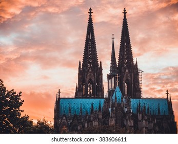 Cologne Dome With Orange Background And Tree On The Left Side