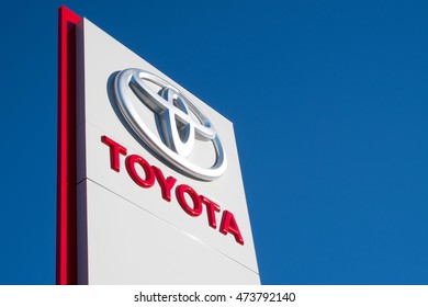 COLOGNE, GERMANY - August 25, 2016: Toyota dealership sign against blue sky. Toyota is the world's market leader in sales of hybrid electric vehicles.