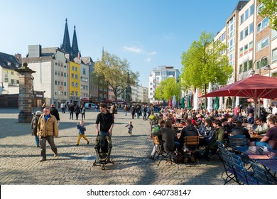 Cologne, Germany - May 01, 2016: Crowded Of People Eating Meal At Neumarkt Square Near The Church Of St. Martin In Cologne, Germany