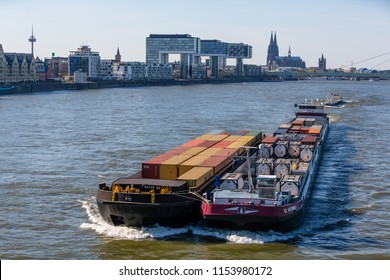 Cologne, Germany: May 5 2016: Cargo Ship ST. ANTONIUS II (ENI 02332893, Built In 2010) As Pusher Train With A Barge Towed Alongside On The River Rhine In Front Of The Skyline Of Cologne.