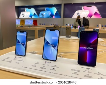 Cologne, Germany - October 01st 2021: A german photographer comparing and testing the new iPhone 13 as well as iPhone 13 Pro and iPhone 13 Mini in an Apple Store.
