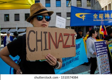 Cologne, Germany -September 14, 2019: Protest Against Christian Persecution In China. The Inscription In German: The Girl Holds A Tablet With An Inscription: Chinazi