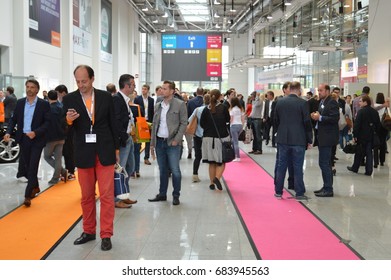 Cologne, Germany - September 16, 2015 - Young business people rushing by on digital marketing exhibition and trade show Dmexco