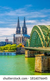 Cologne historical city centre with Cologne Cathedral Roman Catholic Church Saint Peter gothic style building, Hohenzollern Bridge across Rhine river, vertical view, North Rhine-Westphalia, Germany