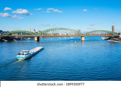 Cologne Koln, Germany, Panorama view of the Rhine River with Hohenzollernbrücke, Cargo Ship and Blue Sky