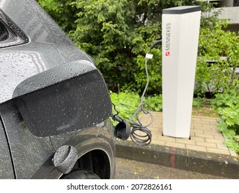 COLOGNE, May 2021: Eletric car charging at Mennekes eMobility charging station on parking lot