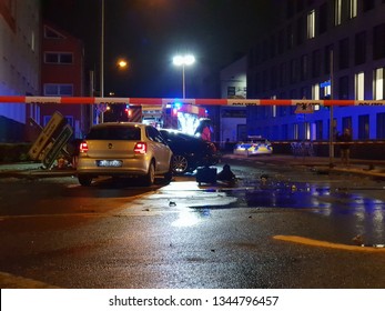 Cologne, NRW / Germany - November 12, 2018: Aftermath Of A Severe Car Accident At Night. Overthrown Traffic Sign. Fire Engine And A Police Warning Tape.