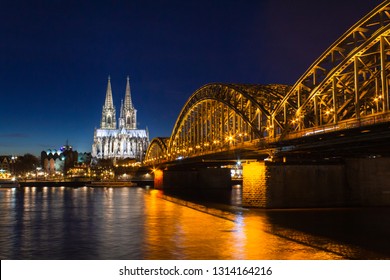 Cologne skyline with Cologne Cathedral and Hohenzollern bridge at night, long exposure shot