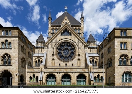the cologne synagogue in neo-romanesque style in front of blue sky with clouds