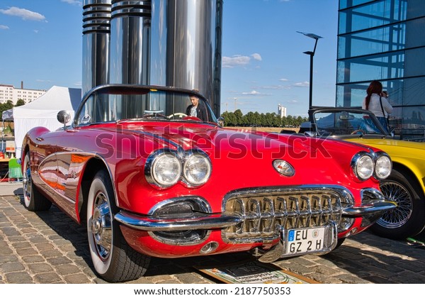 Cologne,Germany,08,06,2022- red chevrolet corvette\
convertible classic c1 from the sixties at the classic car show in\
cologne, diagonal view from the\
front