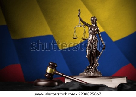 Colombia flag with statue of lady justice, constitution and judge hammer on black drapery. Concept of judgement and punishment