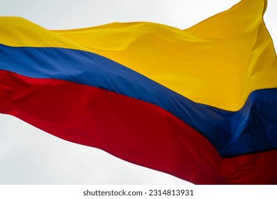 Colombia flag waving in a blue cloudy sky