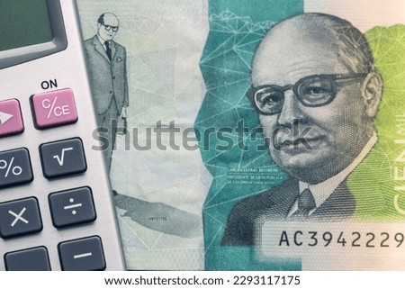 Colombia money, 100 thousand Colombian pesos banknote and calculator, Financial calculation concept, close up