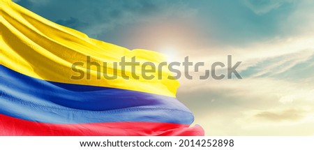 Colombia national flag waving in beautiful sky.