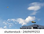 Colombian and Antioquian flag on the top of the smart building. Only one kite in a blue sky whith white clouds. Medellín, Medellin, Antioquia, Colombia. Minimalist picture.