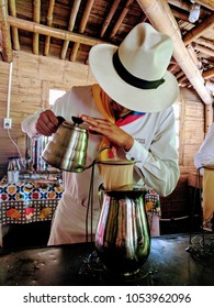 A colombian barista preparing a fresh cup of coffee at the coffee farm in Quindio, Colombia.