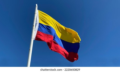 Colombian Flag Waving On Clear Blue Sky