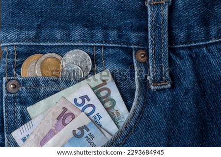 Colombian pesos bills and coins in the pocket